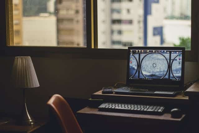 Office workspace with computer and city view for risk management.